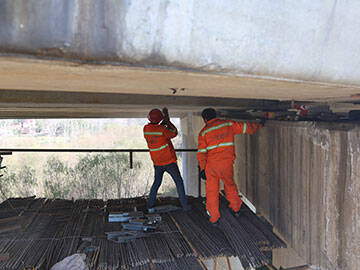 Prestressed FRP laminate system for strengthening the bridge